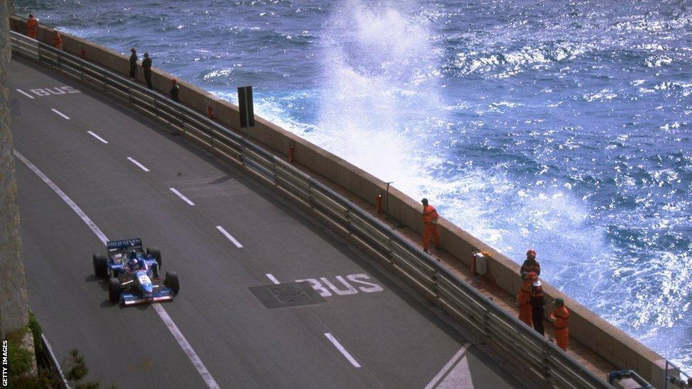 Jean Alesi of France races along the seafront in his Benetton-Renault during the Monaco Grand Prix in Monte Carlo