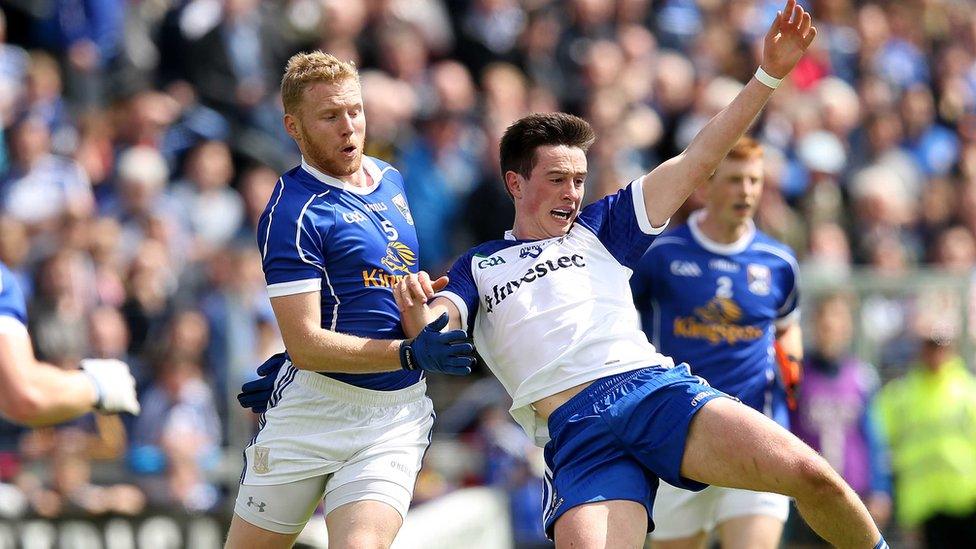 Cavan's James McEnroe pulls back Shane Carey of Monaghan during the game at Breffni Park