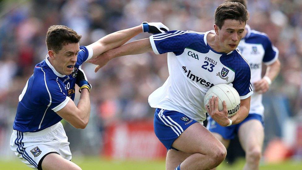 Cavan's Dara McVeety is fended off by Shane Carey of Monaghan during the Championship clash