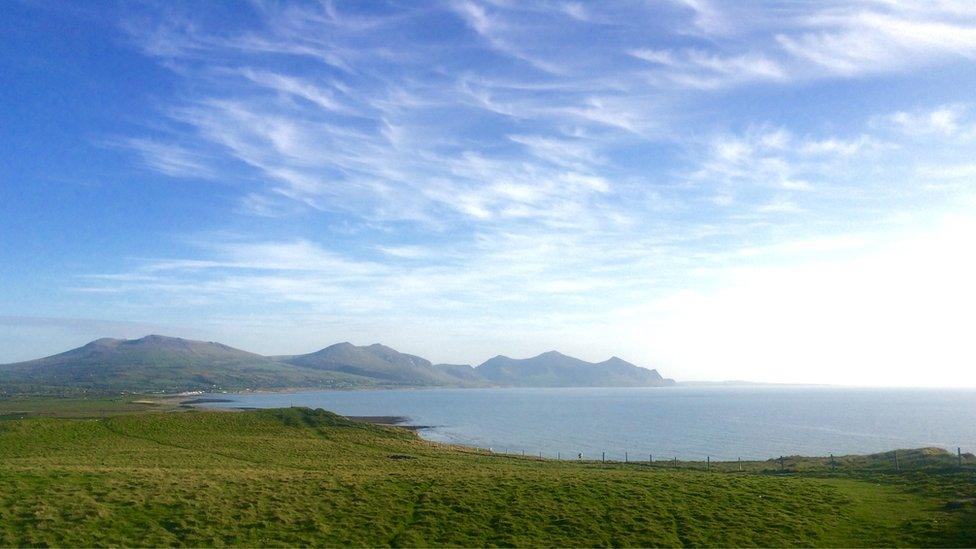 Blue skies at Dinas Dinlle near Caernarfon, looking at the "Three Sisters" mountains, as seen by Rhiannon Thomas