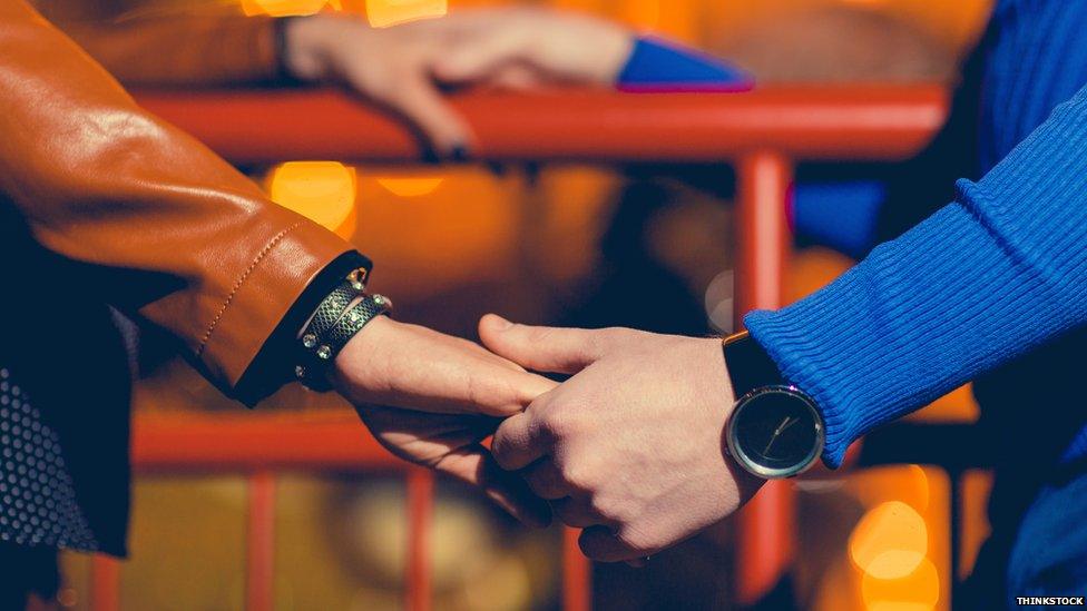 Two people holding hands