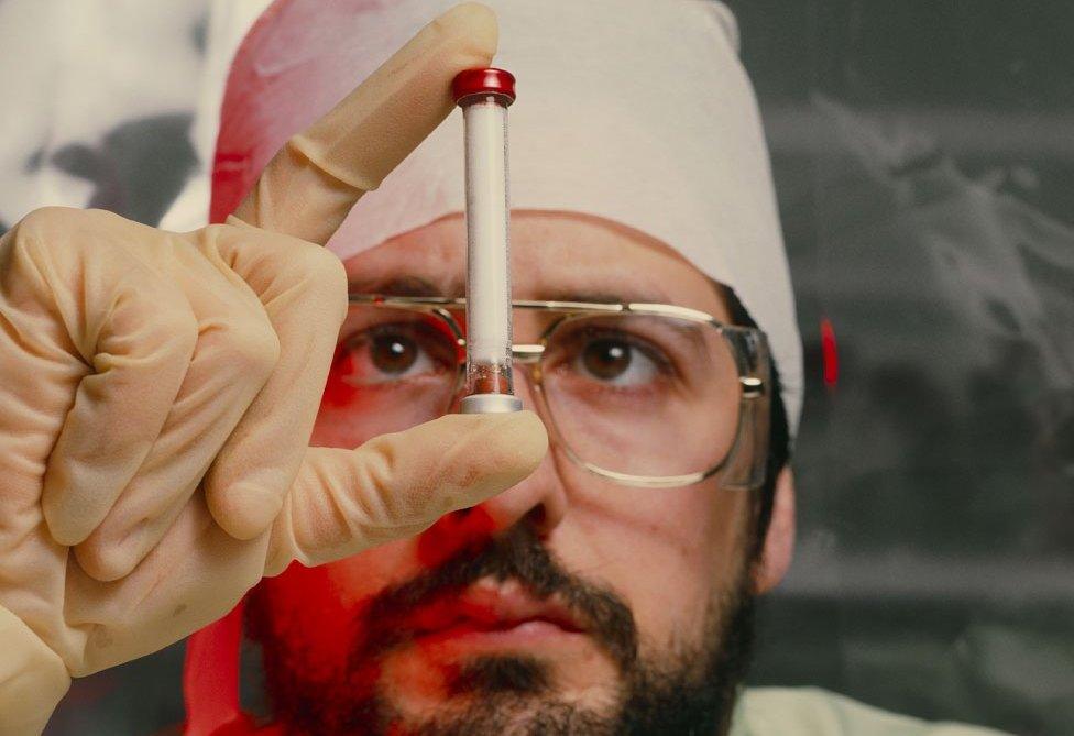 A man inspects a column for a technetium-99m