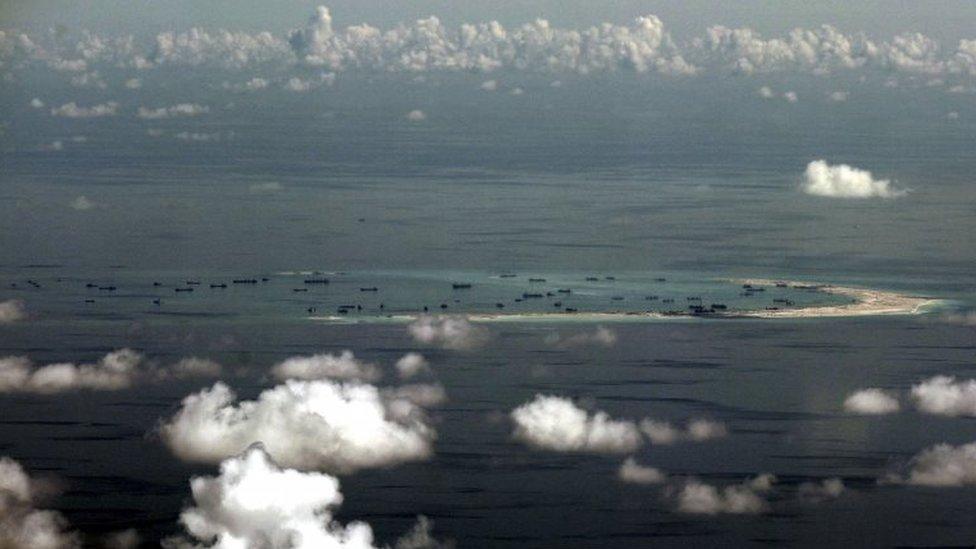 An aerial file photo taken though a glass window of a Philippine military plane shows the alleged on-going land reclamation by China on mischief reef in the Spratly Islands in the South China Sea