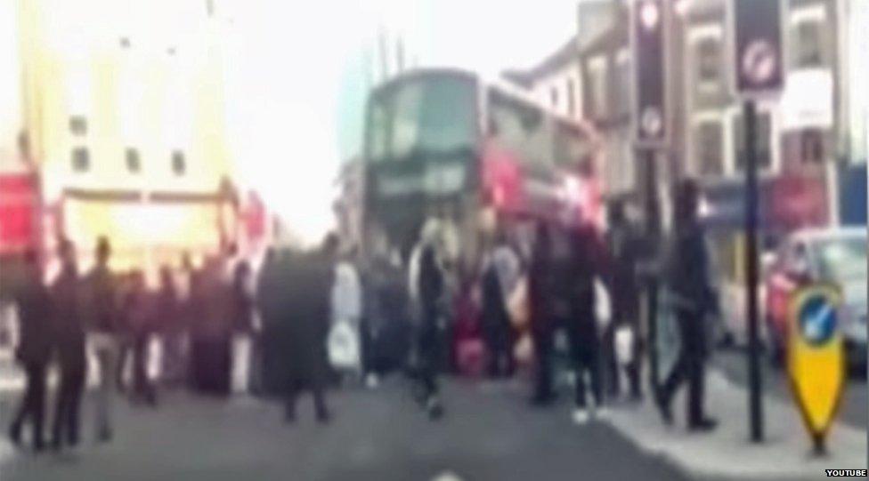 Blurry video grab of crowd around bus in Walthamstow