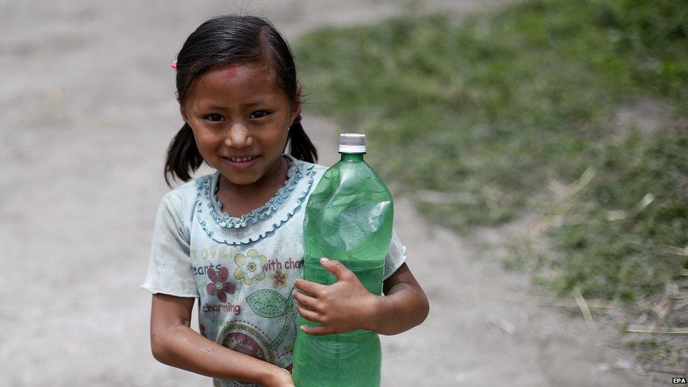 Small girl holding a bottle of water