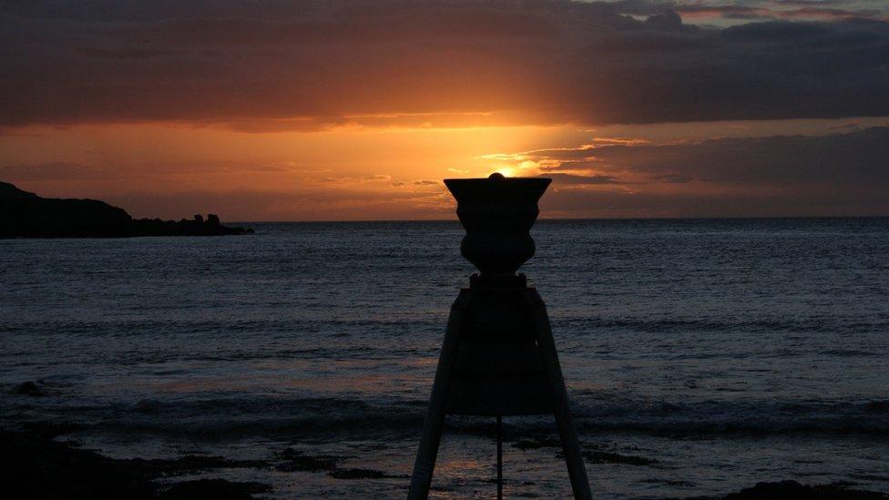 Cemaes Bay Time and Tide Bell, Anglesey, captured in alignment with the sunset by Lisa Hooton, of Llanddeusant, Anglesey