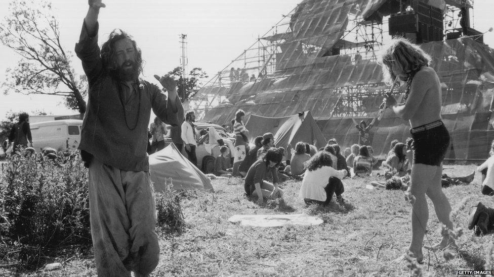 Men dancing by the Pyramid Stage