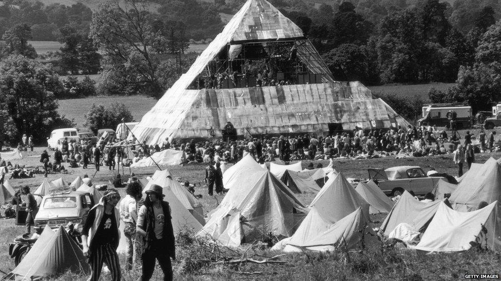 Tents and people in front of the Pyramid Stage