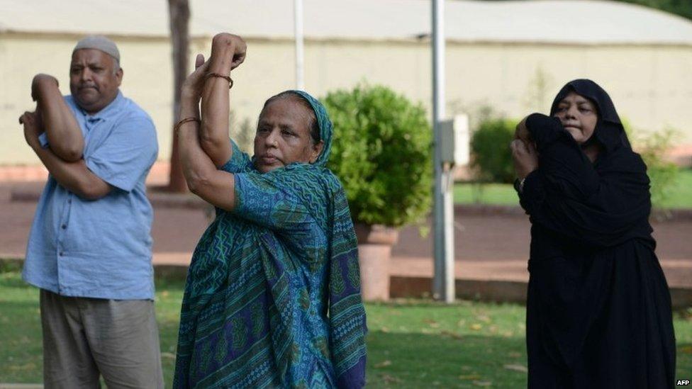 Indian residents take part in a yoga workshop conducted by unseen yoga teacher Chandrikaben Kansara, 57, ahead of International Yoga Day at Sardar Bagh in Ahmedabad on June 14, 2015