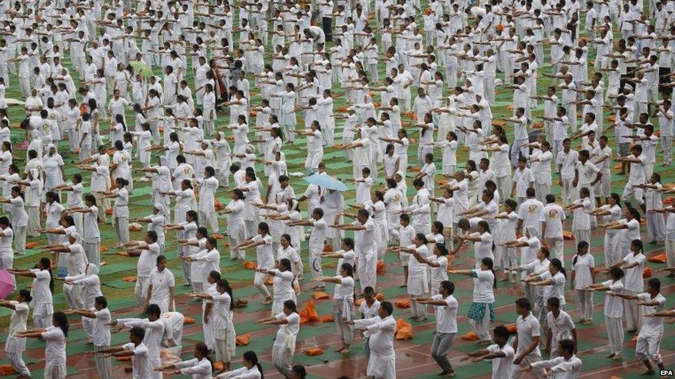 Indian yoga practitioners take part in the Yoga rehearsal camp for the International Yoga Day in heavy rain at Jawaharlal Nehru Stadium in New Delhi, India, 14 June 2015.