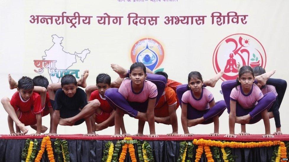 Young Indian Yoga enthusiasts take part in the Yoga rehearsal camp for the International Yoga Day in heavy rain at Jawaharlal Lal Nehru Stadium in New Delhi, India, 14 June 2015.