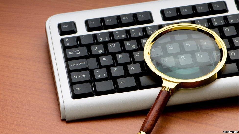 Magnifying glass on computer keyboard