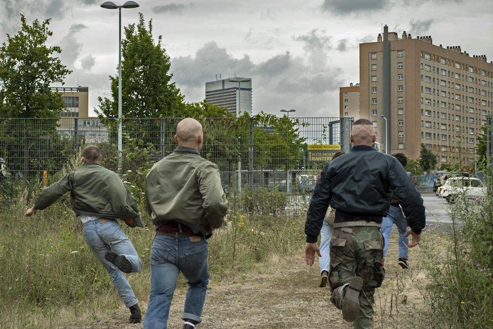 Scene from the film - men running away