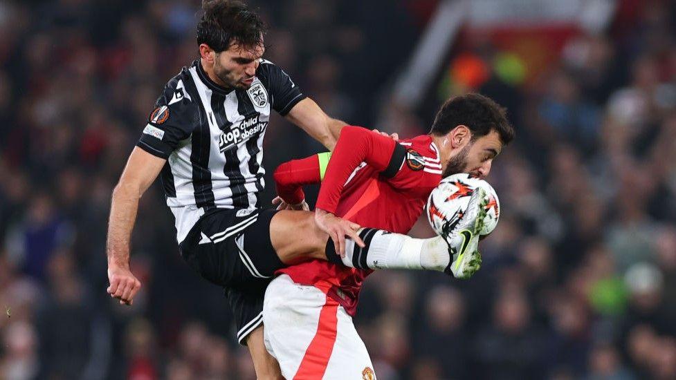 Manchester United captain Bruno Fernandes battles for possession in the Europa League against Greek side PAOK.