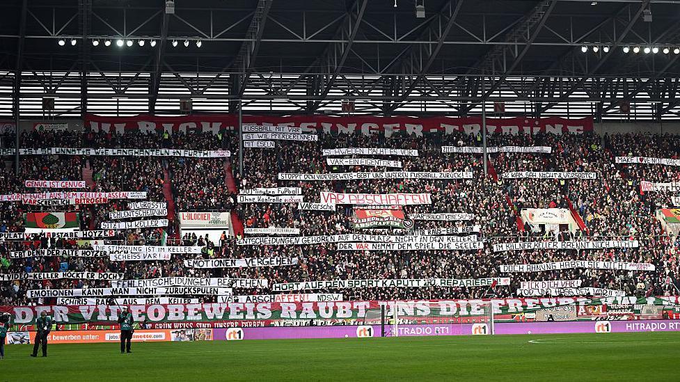 Fans of FC Augsburg display banners in protest of VAR prior to the Bundesliga match against 1. FC Heidenheim