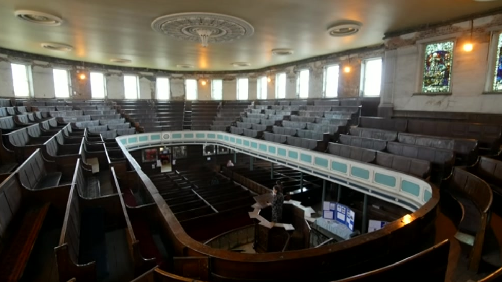 Inside view from upstairs in the chapel showing brown seats in a circular formation