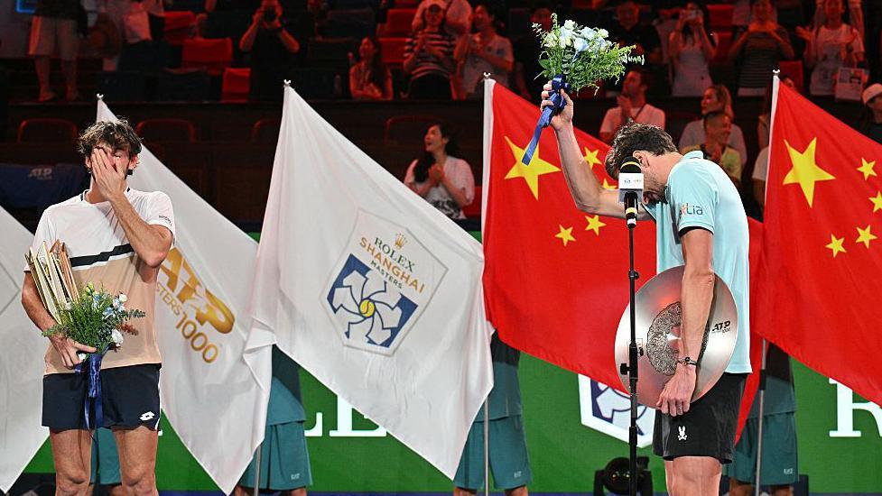 Both players wiping away tears during the post-match ceremony