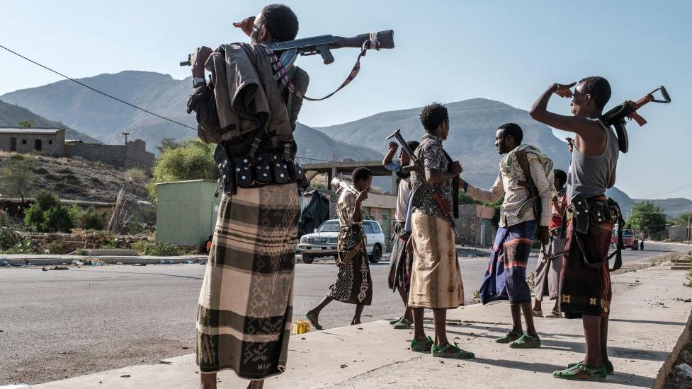 Armed members of Afar militia stand at a checkpoint in Ethiopia