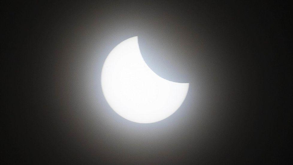 An eclipse, with the moon covering the upper right portion of the sun.
