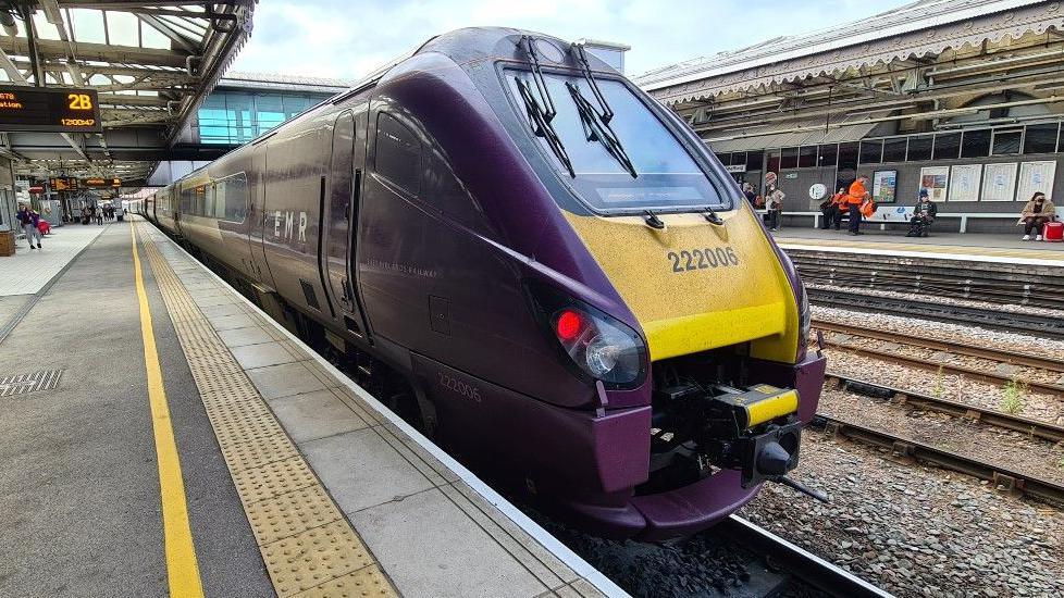 An East Midlands Railway train stopped at a Sheffield station.