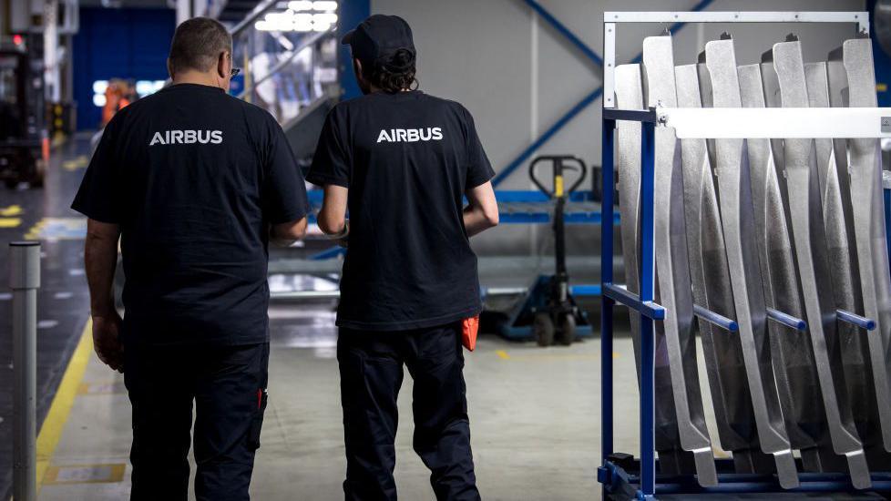 Airbus employees in a factory in France from behind