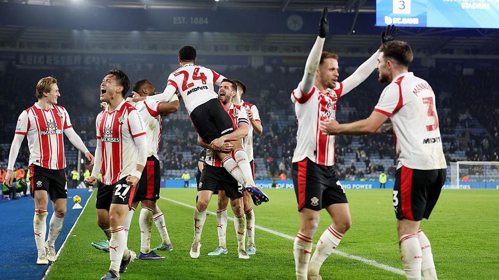 Southampton players celebrate a late winner from Shea Charles in their victory over Leicester as the goalscorer is lifted in the air