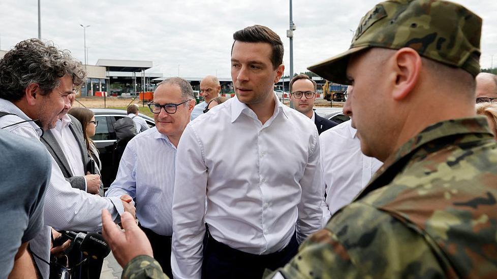 French far-right Rassemblement National (RN) party's President, member of the European Parliament and president of the Patriots for Europe (PfE) group Jordan Bardella (C) arrive for a visit to Poland's border with Belarus near Kuznica, eastern Poland