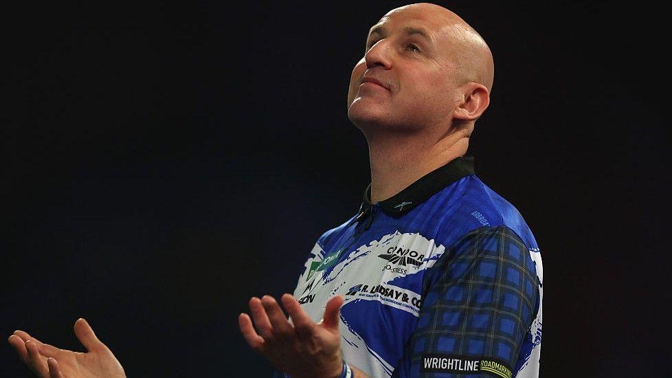 Alan Soutar raises his hands at Alexandra Palace