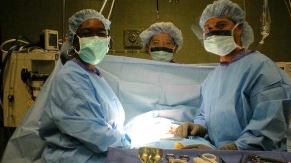 Photo of Dr Rebecca Alleyne during surgery wearing he surgical scrubs