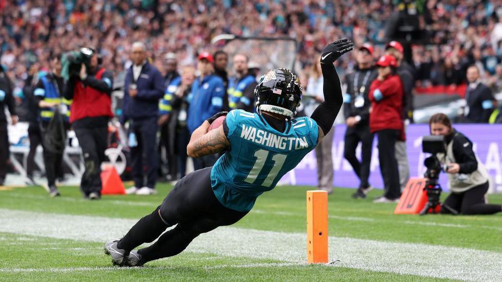 Parker Washington celebrates scoring a touchdown for the Jacksonville Jaguars at Wembley by falling into the end zone