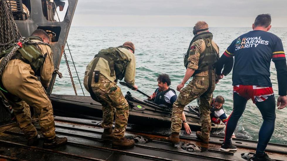 Kayakers are pulled out of the sea