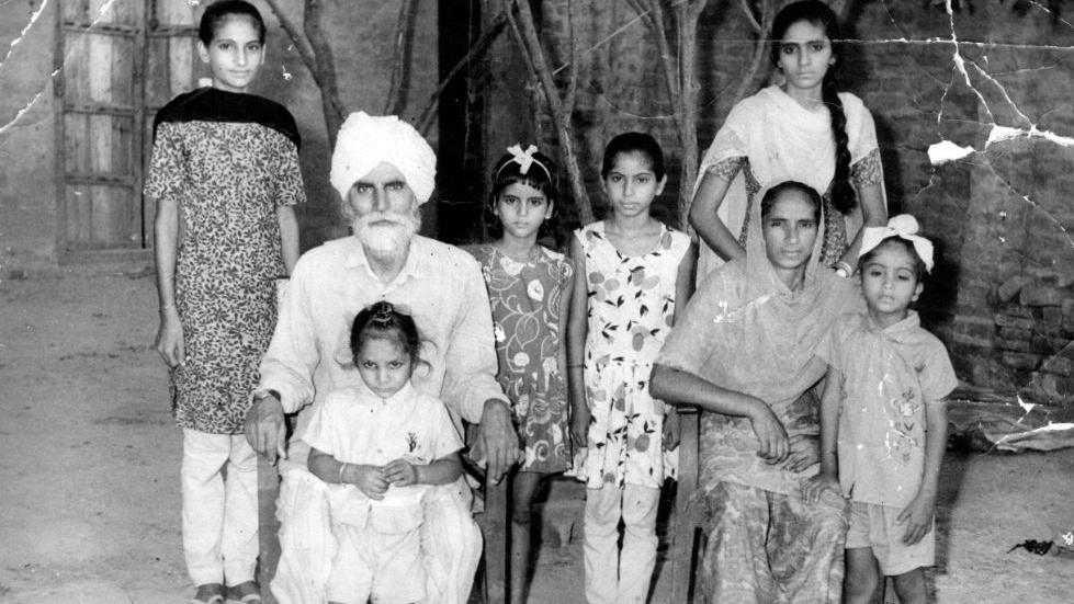 A black and white photograph of a family in Punjab, India.