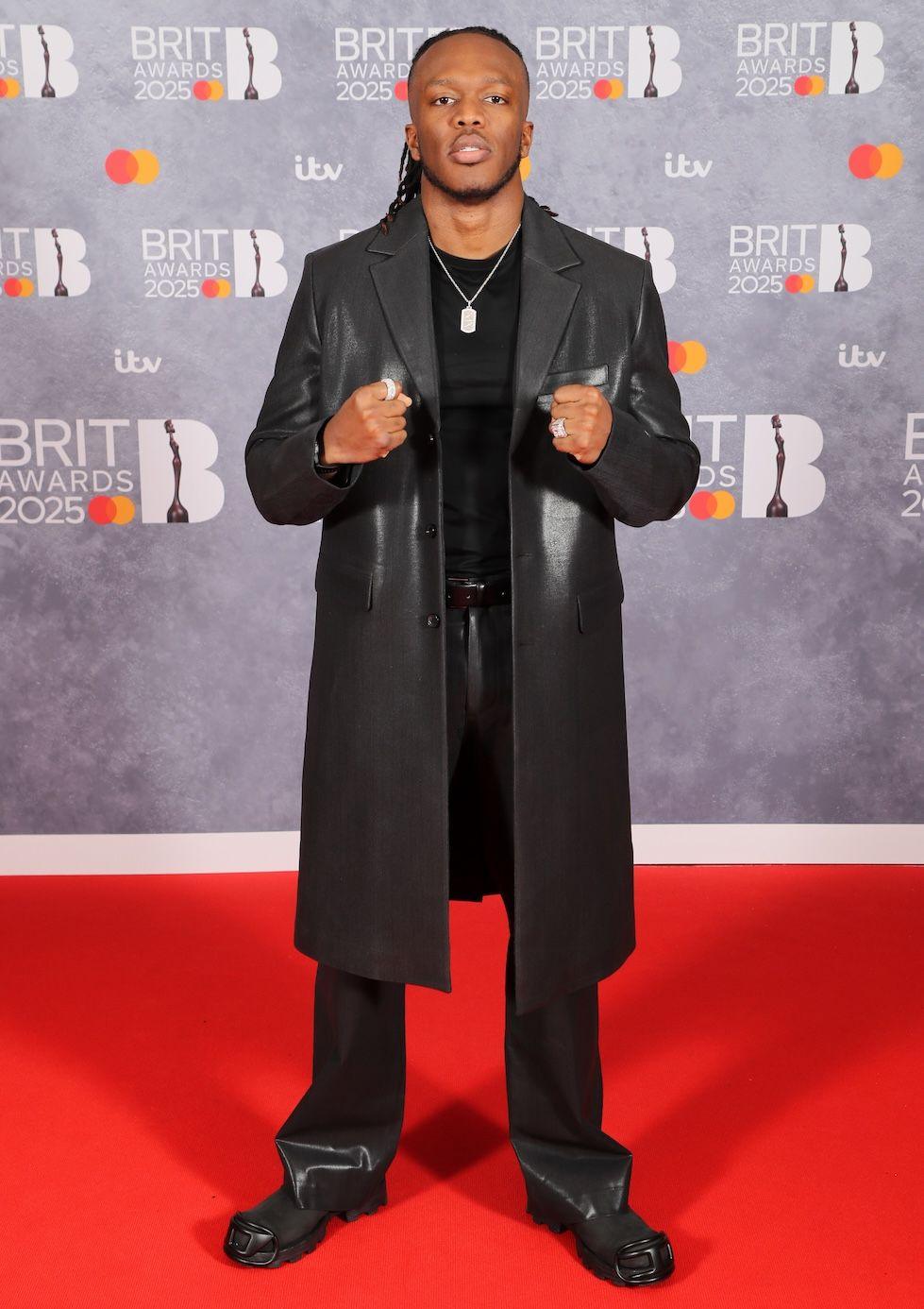 KSI wears an all black outfit on the red carpet at the O2