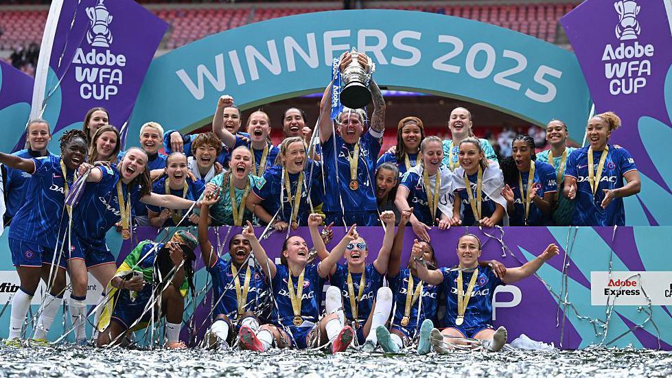 Chelsea captain Millie Bright (centre) lifts the FA Cup surrounded by her teammates