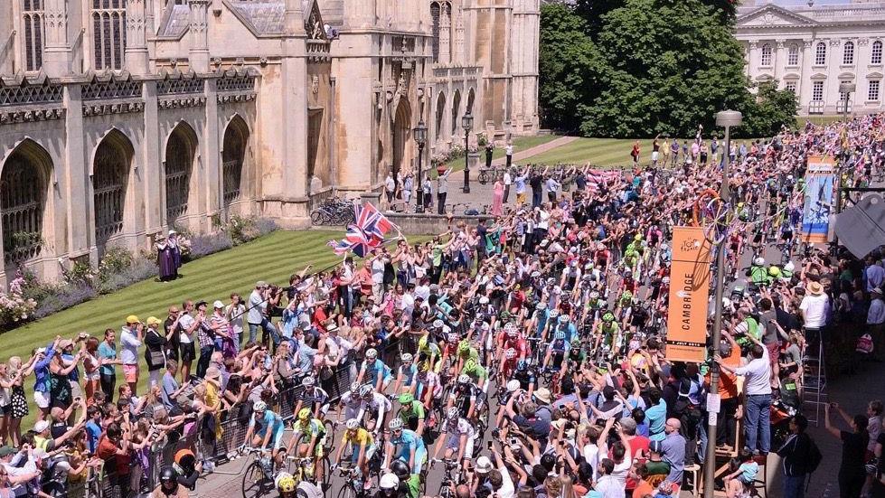 Tour de France cyclists moving down King's Parade, Cambridge, July 2014, with croweds standing and applauding on either side