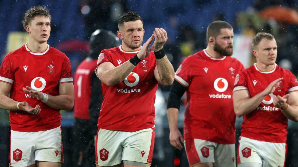 Dejected Wales players applaud fans after defeat in Italy