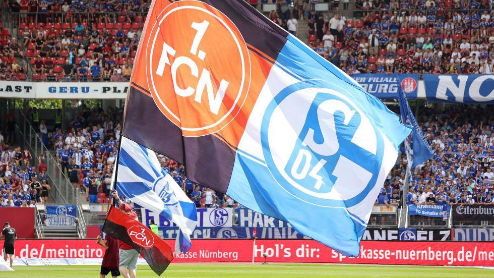 Fans of Schalke and Nuremberg with a half-and-half flag