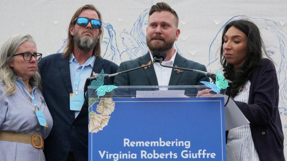 Virginia Giuffre's brothers, Sky Roberts (second right) and Danny Wilson, and her sisters-in-law, Lanette Wilson (on left) and Amanda Roberts, stand together during a "butterfly" vigil commemorating the one-year anniversary of the death of Virginia Roberts Giuffre.