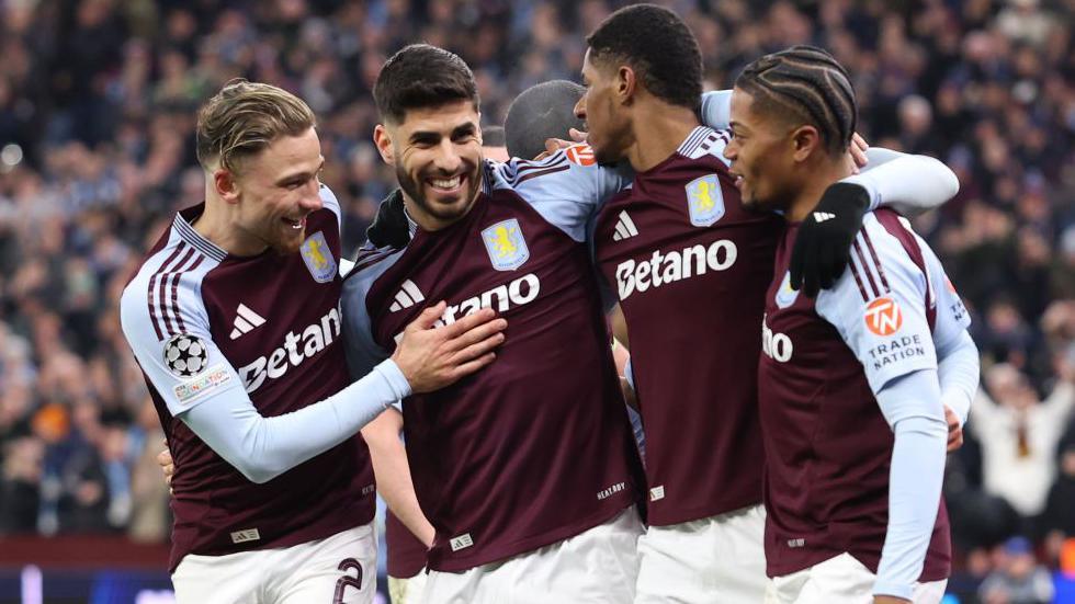 Aston Villa's players celebrate after Marcus Rashford set up Marco Asensio for their third goal against Club Brugge