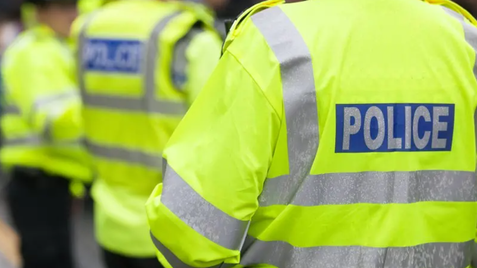 A police officer wearing a fluorescent jacket