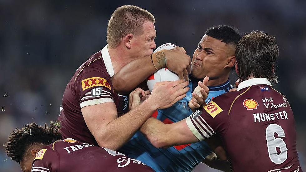 Haumole Olakau'atu of New South Wales is tackled during the game