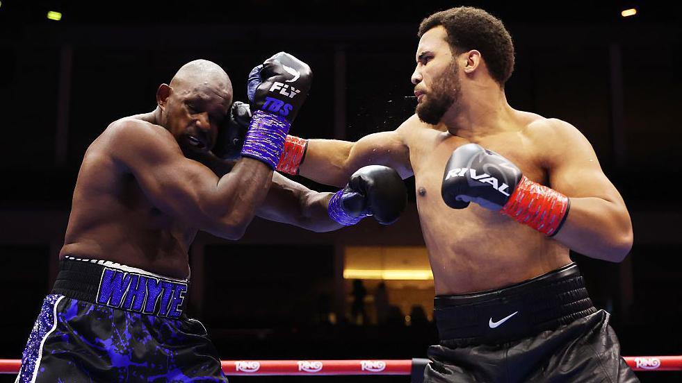 Dillian Whyte's face contorts as he is punched by Moses Itauma