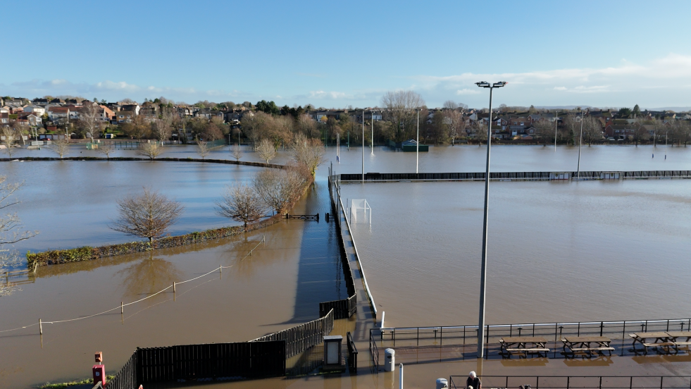 Lydney football pitch completely submerged in water seen in a picture taken from the air. Floodwaters are also covering much of the surrounding area