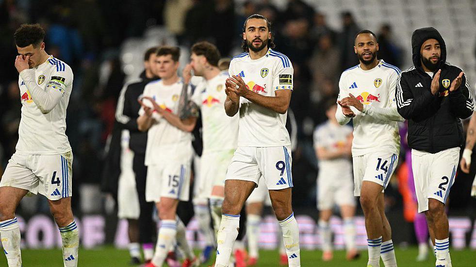 Leeds players applaud their fans