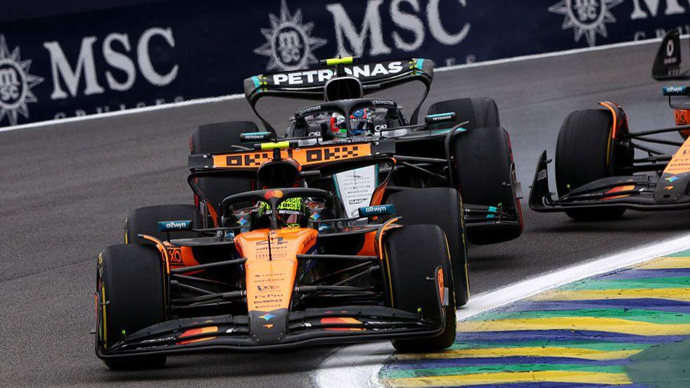 McLaren's Lando Norris leads as the Mercedes of Kimi Antonelli and McLaren of Oscar Piastri make contact behind him