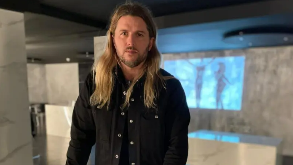 Celebrity chef Michael O'Hare in a dark shirt stood against a blurred background 