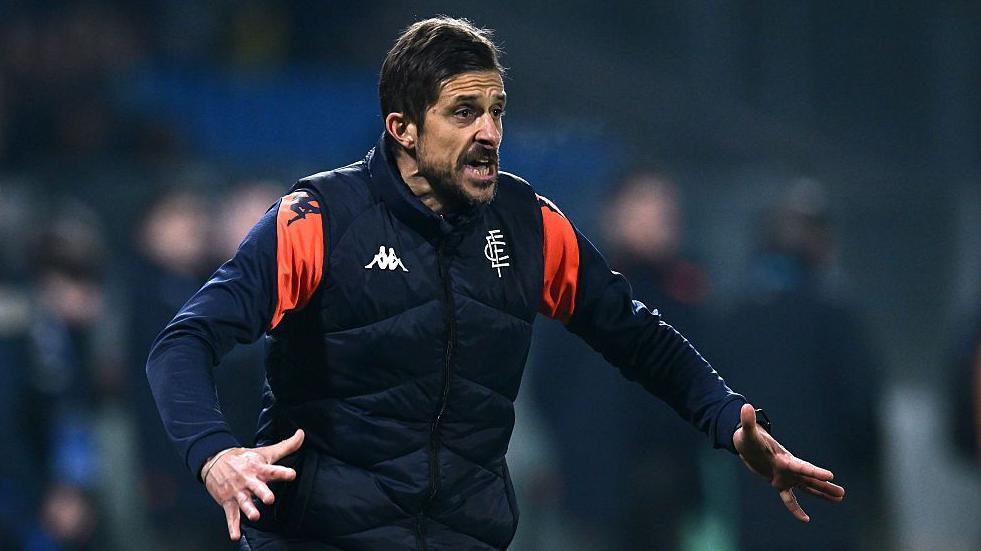 Alessio Dionisi pictured on the sidelines coaching Empoli in a dark blue training top