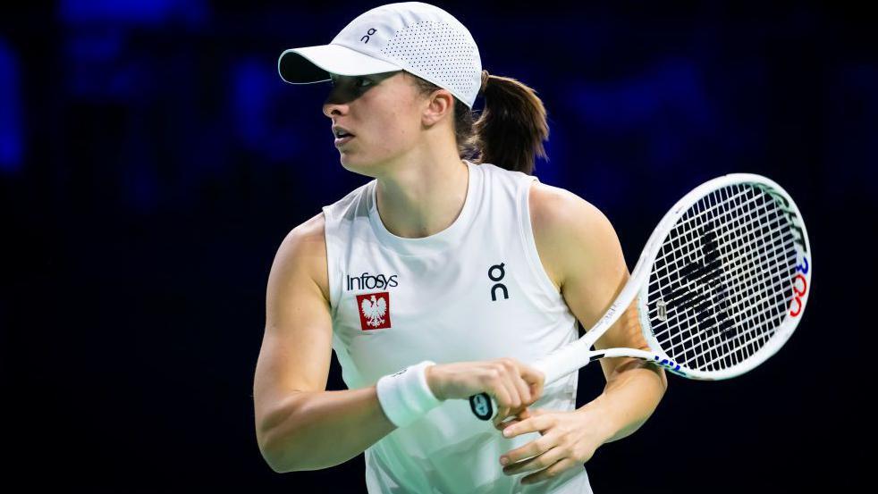 Iga Swiatek holding racket during a Billie Jean King Cup match