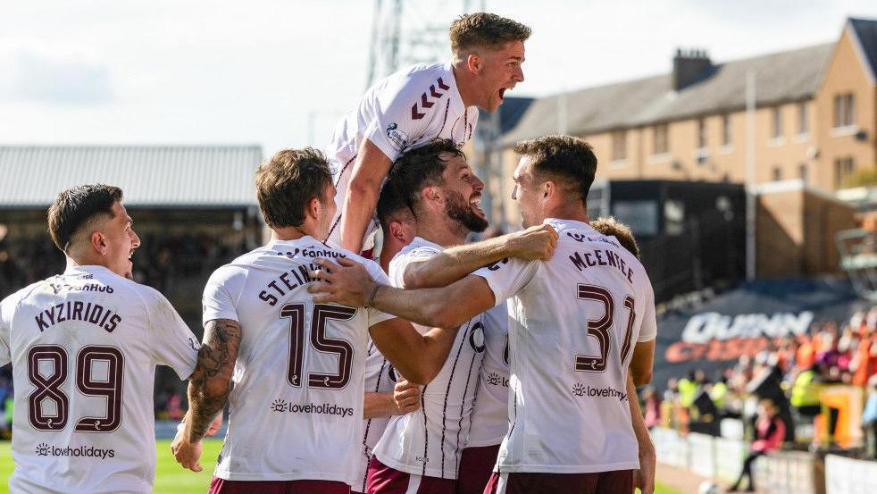 Hearts' Stuart Finday celebrates with the Hearts squad after scoring to make it 3-2