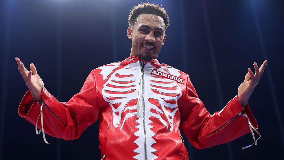 Ben Whittaker wearing a red jacket with a white skeleton pattern on the chest